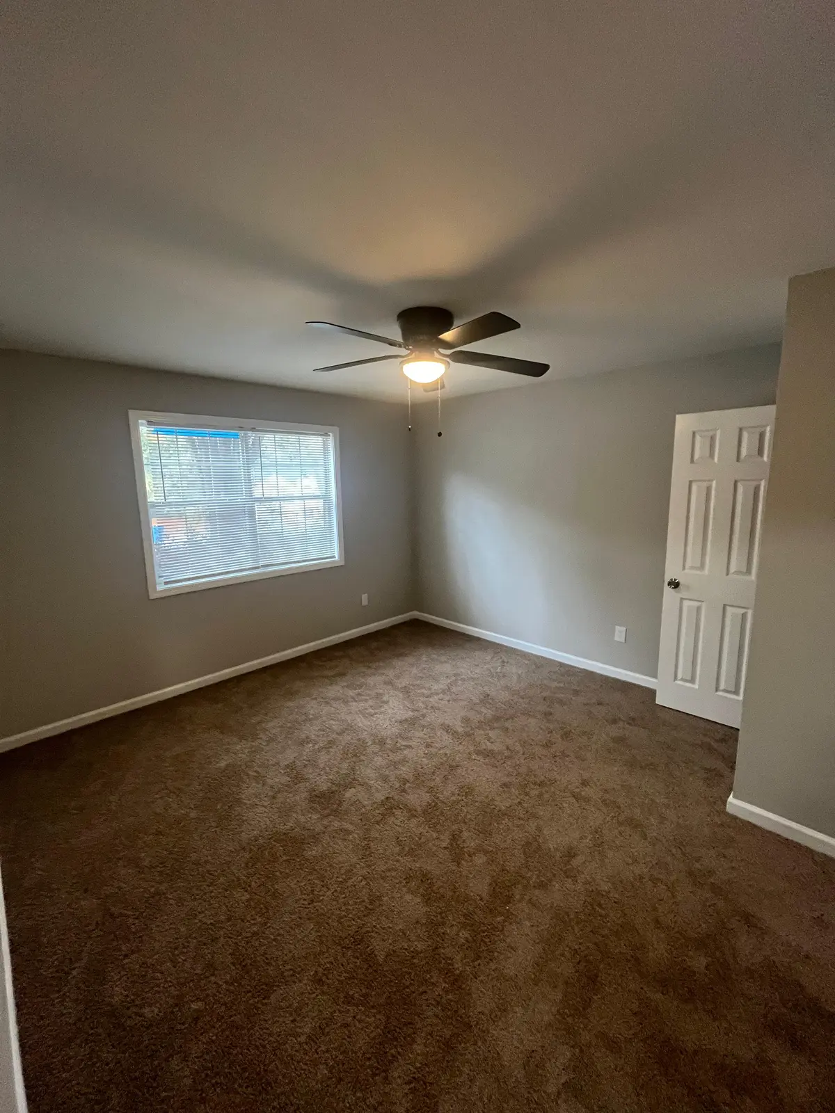 Bedroom after: walls patched, sanded and painted gray with white trim