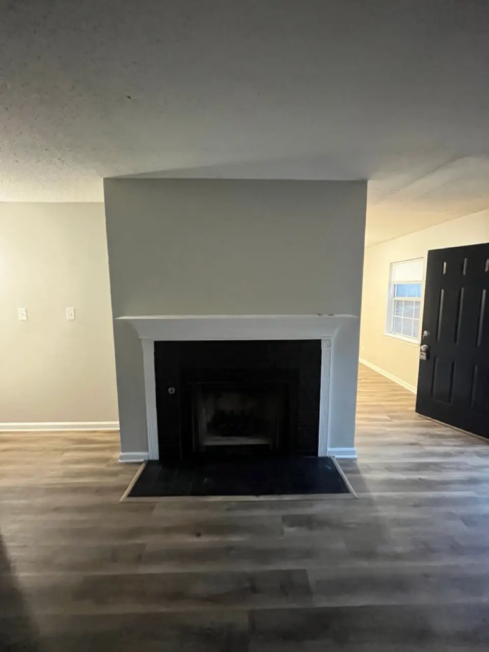 Fireplace after: brick surround painted black, mantel refreshed white